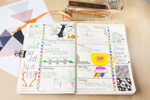 A bullet journal featuring a Halloween-themed weekly spread with cobweb doodles, pumpkins, and gratitude prompts.